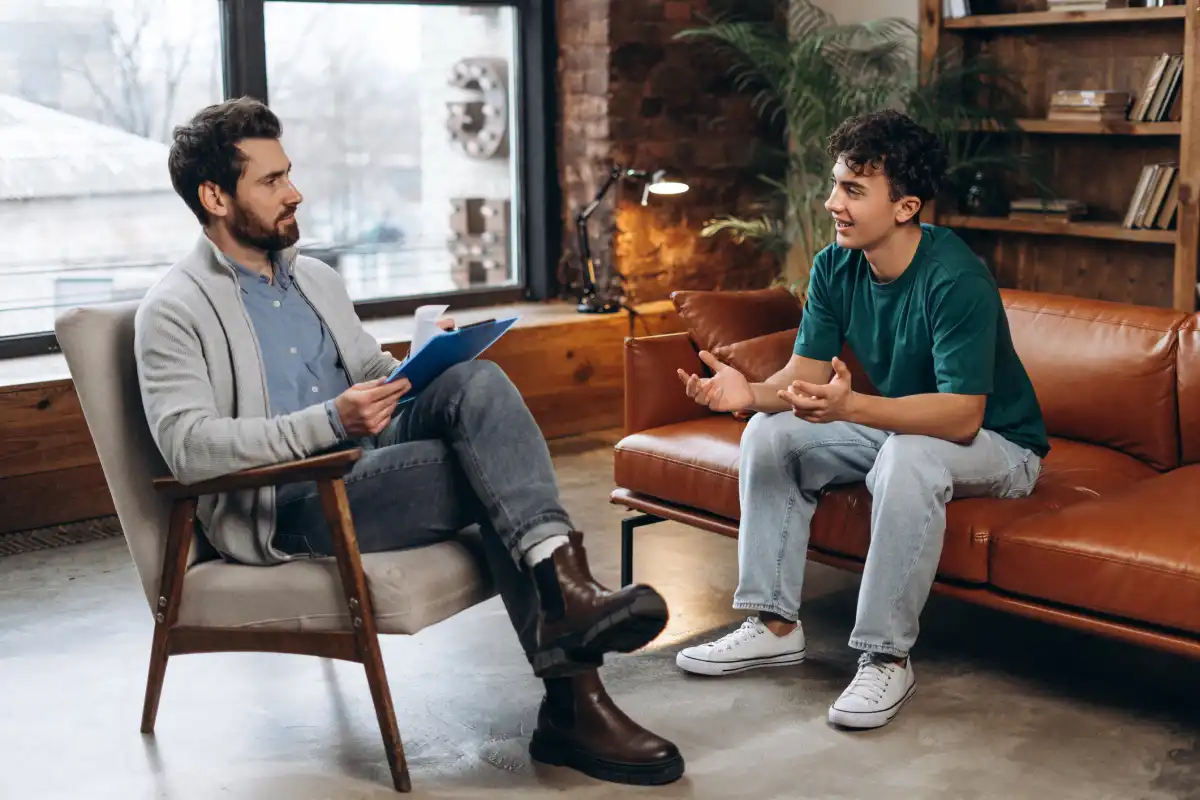A psychologist meets with a client in an office.    