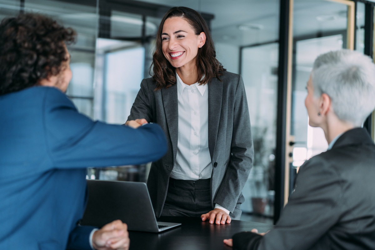 A risk management consultant meets with client leadership in the office.