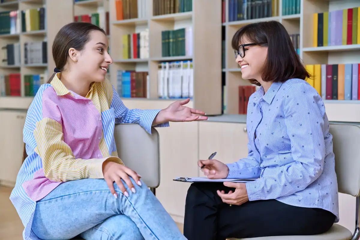 A school counselor talks with a student about educational and career goals.