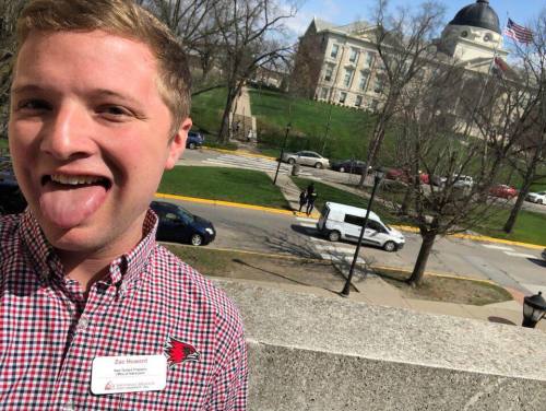 A selfie of Zac on the balcony at the UC with Academic Hall in the background