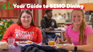 Two students smiling at the camera in the Towers Complex dining hall during SEMO's Late-Night Breakfast tradition. The title above reads, "Your Guide to SEMO Dining."