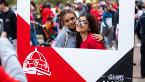 Students pose for a photo at SEMO Alumni photo booth