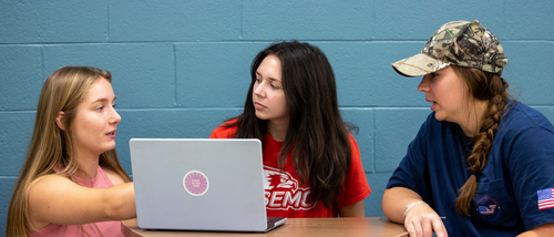 Mass media students discuss a project in class.