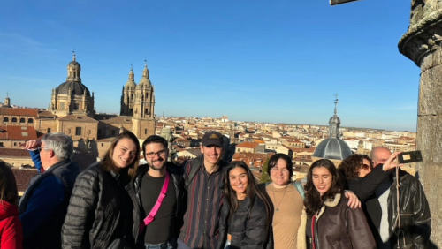 Trent with five friends on a rooftop during a sunny day in Spain during his study abroad trip