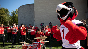 Rowdy the Redhawk, SEMOs Mascot, stands in front of the Southeast Band.