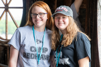 Two incoming SEMO students in smiling together in the Dome at Camp Redhawk. 