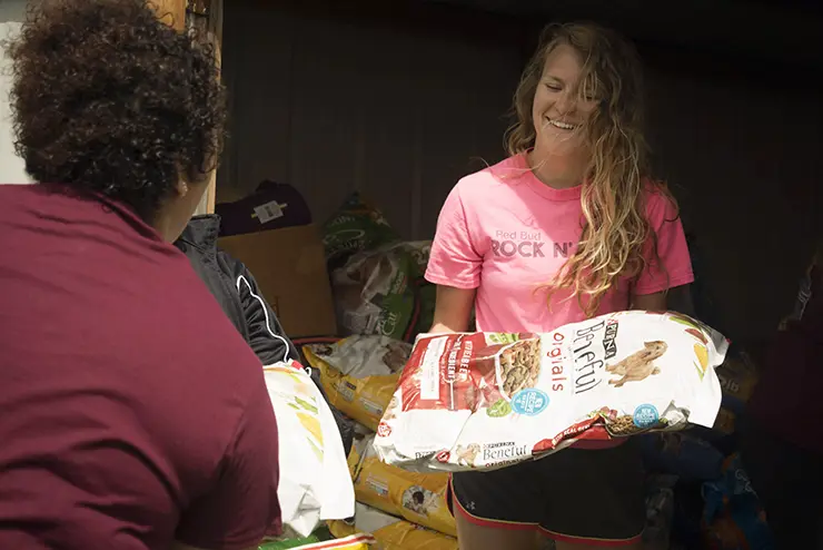 SEMO students help stack bags of dog food for the animal shelter