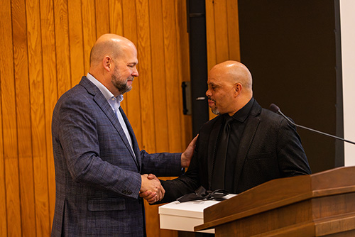 Dr. Hodson greeting the MLK Dinner speaker Adrian Taylor.