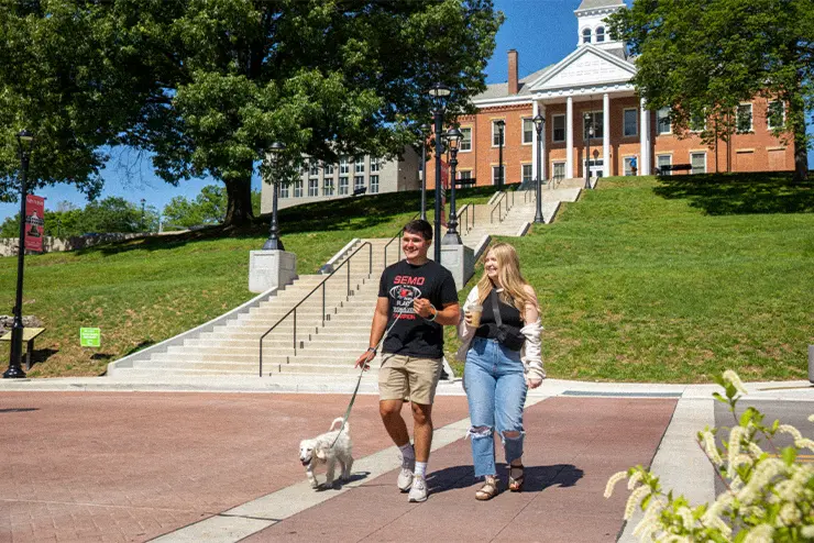 2 SEMO College Students walking with their Dog in beautiful Cape Girardeau Downtown ranked #5 in top small college towns in the United States. 