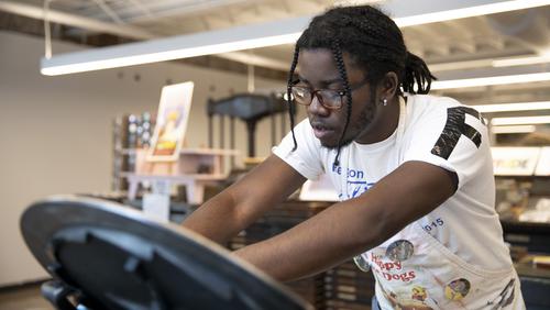 An art student uses the letterpress for a project at Catapult Creative House.