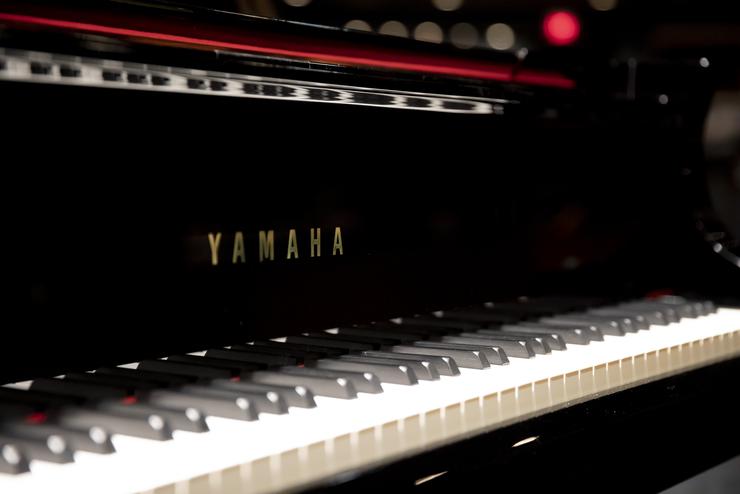 A close up of the keyboard of a Yamaha piano.