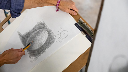 A student works on a drawing.
