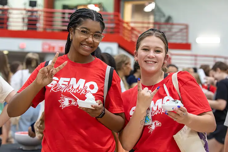 two semo students pose for a photo at an opening week event