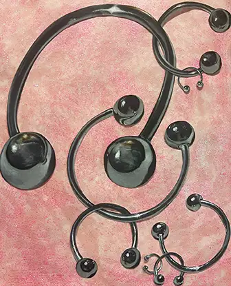 a drawing featuring pieces of u-shaped metal with balls at the end in the style of body piercings such as belly or tongue