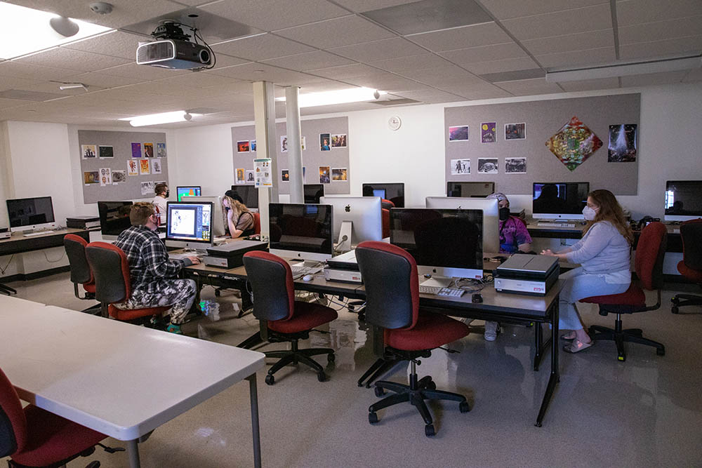Professor Emily Denlinger assists her students while they create digital art at Southeast Missouri State University on March 24, 2021, in Cape Girardeau, Missouri. 