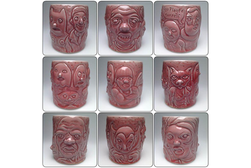 A grid of 9 maroon ceramic mugs with faces and characters engraved on them. 