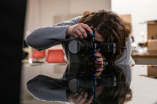 a photography student sets up to take a photo in the photo studio