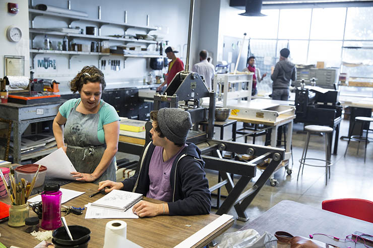 an art and design student and their instructor work together in the printmaking studio in creating the student's art