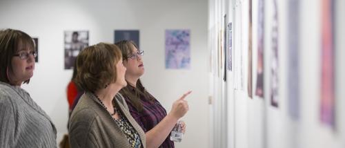 Attendees view art inside the River Campus Art Gallery at Southeast Missouri State University in Cape Girardeau, Missouri.