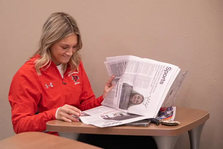 A college student working on a school news paper while doing research for her practicum at SEMO getting career ready skills