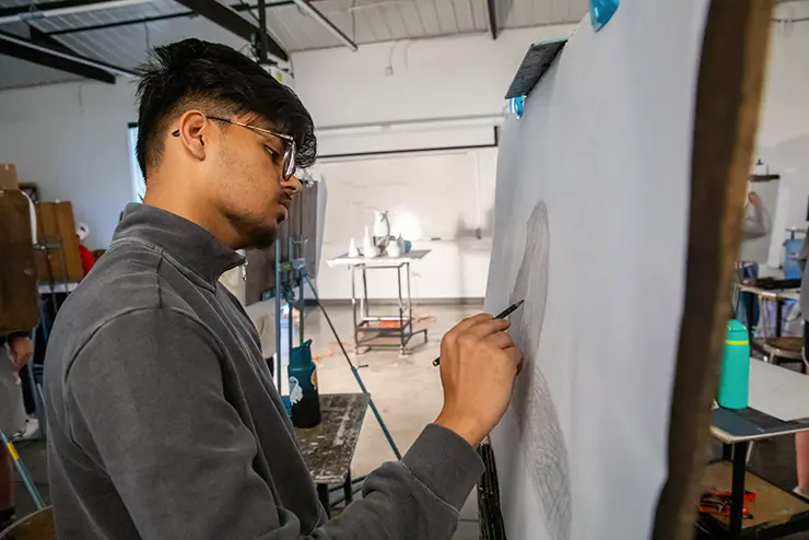 a SEMO drawing student works on a project in class