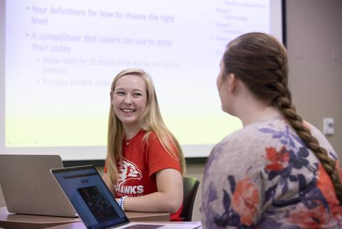 Two mass media students interact during class at Grauel.  