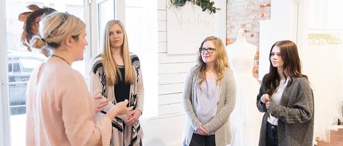 Three advertising students meet with Renee Clements, Southeast alumna and owner of Magnolias Bridal, for a project.  