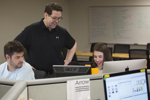 Two students working for The Arrow network with Lucas Presson, assistant publisher at the Southeast Missourian. 