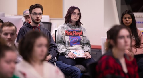 A group of Mass Media students sit in the Arrow lab.