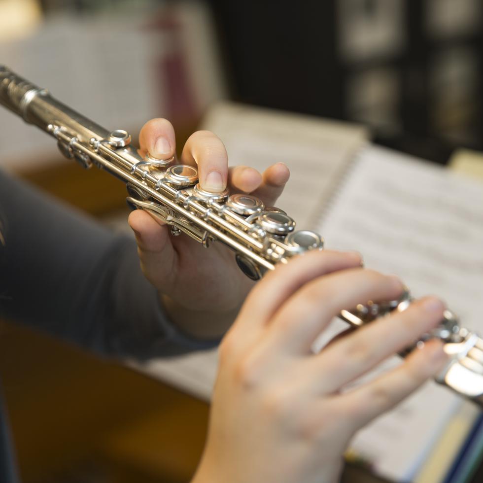 Student practices playing the flute 