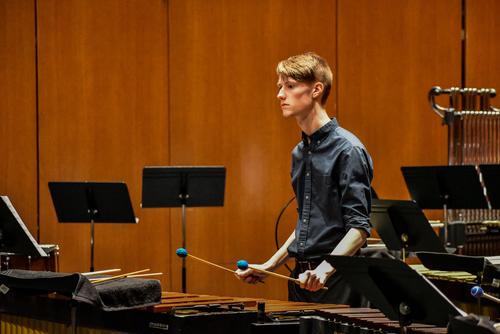  Student practices percussion instruments for ensemble 