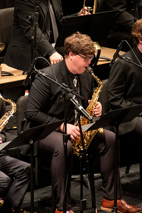 A student playing the tenor saxophone.