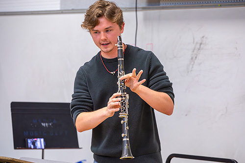 A student shows how to hold a clarinet during instrumental techniques
