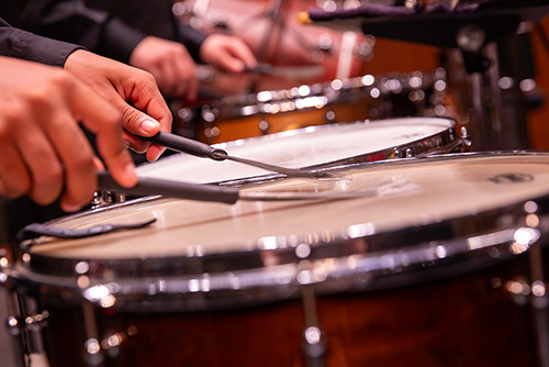 AN image of someone playing the snare drums.