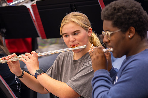 Two flute players play together.