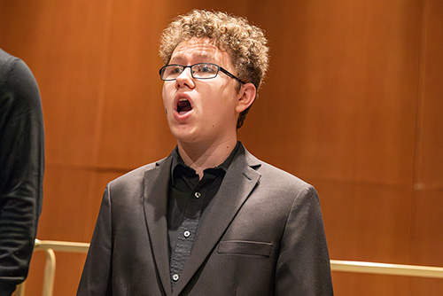 Student sings during concert featuring choral ensemble 