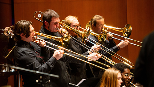 Three students play the trombone during the jazz concert.