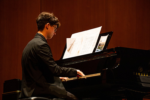   Student plays the piano while performing with Jazz Band. 