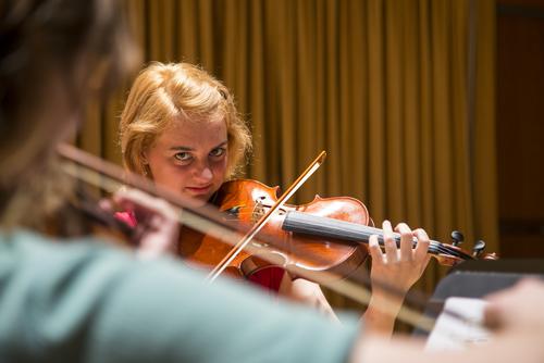 A student plays a violin in Shuck Performance Hall.
