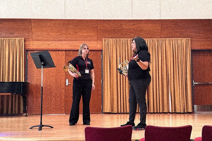 A student shows how to hold a clarinet during instrumental techniques