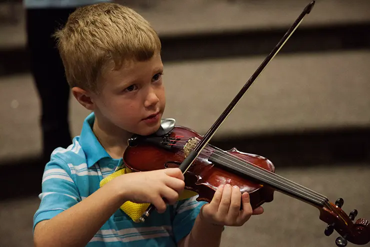 a young participant in SEMO's music academy practices the violin
