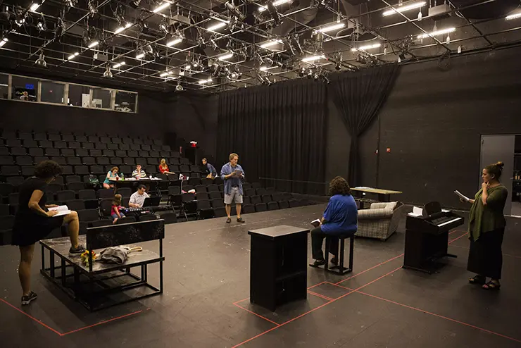 a group of theatre students rehearse a performance in rust flexible theatre