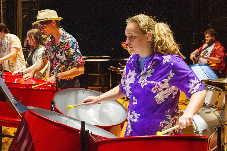 a group of semo students in the steel drum band performs on their drum sets