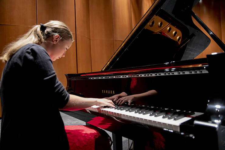 a student in the music department at southeast missouri state univeristy plays a yamaha piano