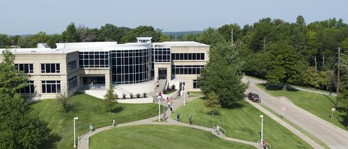 Students walk near Dempster Hall as seen from the air.