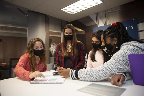 Students work around a table in the hospitality management lab.