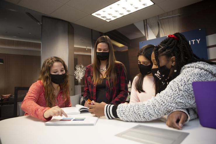 Students work around a table in the hospitality management lab.