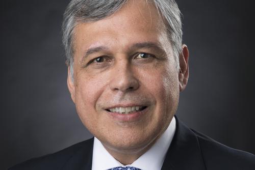 Alberto Dávila smiles for a portrait.