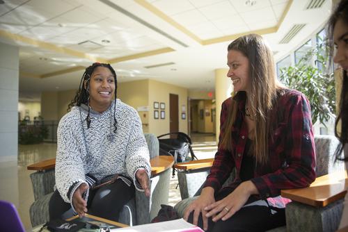 SEMO classmates discuss an assignment between classes in Dempster Hall. 