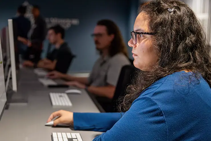 a SEMO computer science student sits at a computer and works